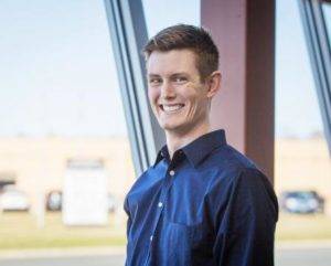 Professional headshot of a man wearing a blue button down shirt