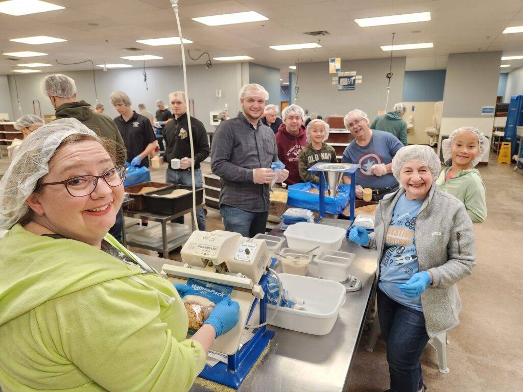 Employees volunteering for Feed My Starving Children