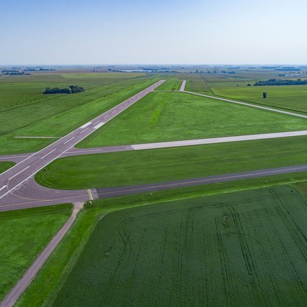 A rural runway with taxi lanes nestled amidst vast fields