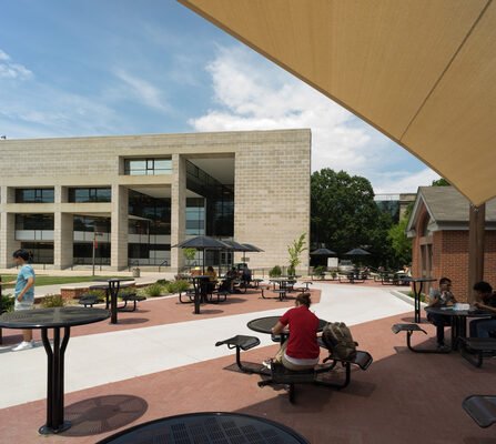 Urban landscape featuring various public seating options with buildings in the backdrop