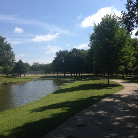 Visualization of a river flowing through a lush park with greenery and a paved walking path