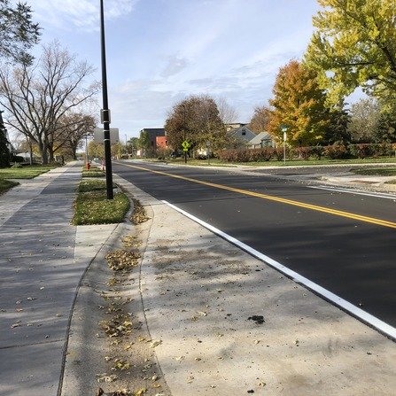 A quiet residential street with sidewalks on both sides