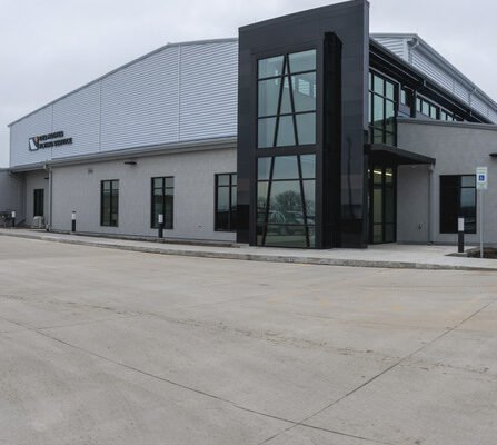 A modern airport exterior featuring large windows and contemporary architecture