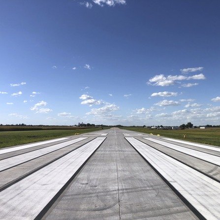 A paved runway marked with white lines
