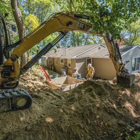 Workers excavating in residential area for lake sanitary collection system