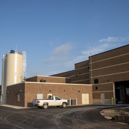 Large brick building with truck parked outside