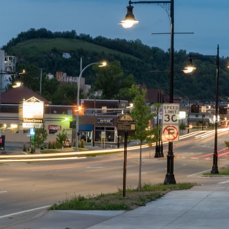 A time-lapse showcases a lively street corridor after dark, with a series of restaurants and office buildings
