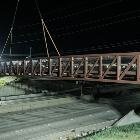 Large bridge is firmly held in place by a crane