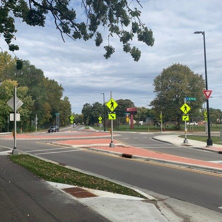 Cars navigating a roundabout with multiple lanes and exits