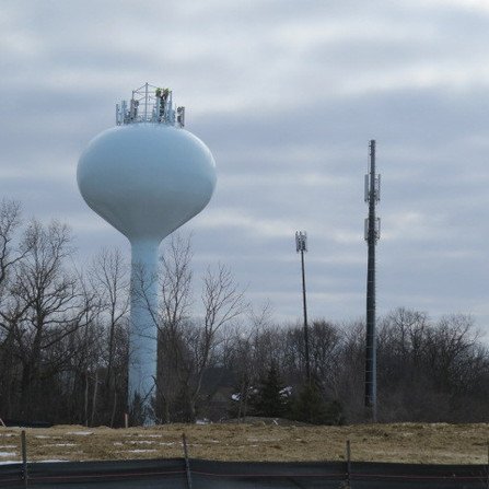 A water tower surrounded by trees