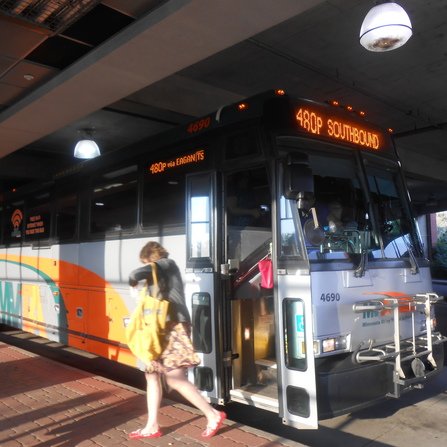 A transit bus dropping off a commuter