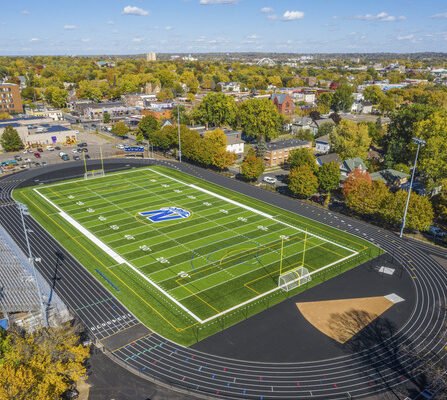 Birds eye view of a sports complex; equipped with track, soccer, and football field