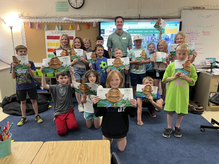 A group of children holding up books