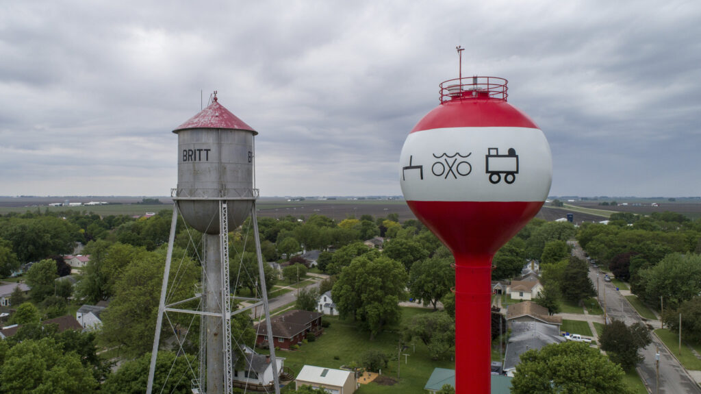 The City of Britt’s water tower contains symbols to indicate this is the place with a freshwater campsite and a train stop
