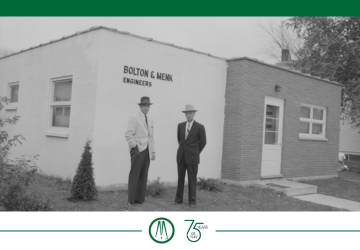 John Bolton and Martin Menk by the entrance of an early office
