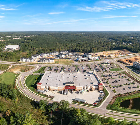 A large building surrounded roads and trees